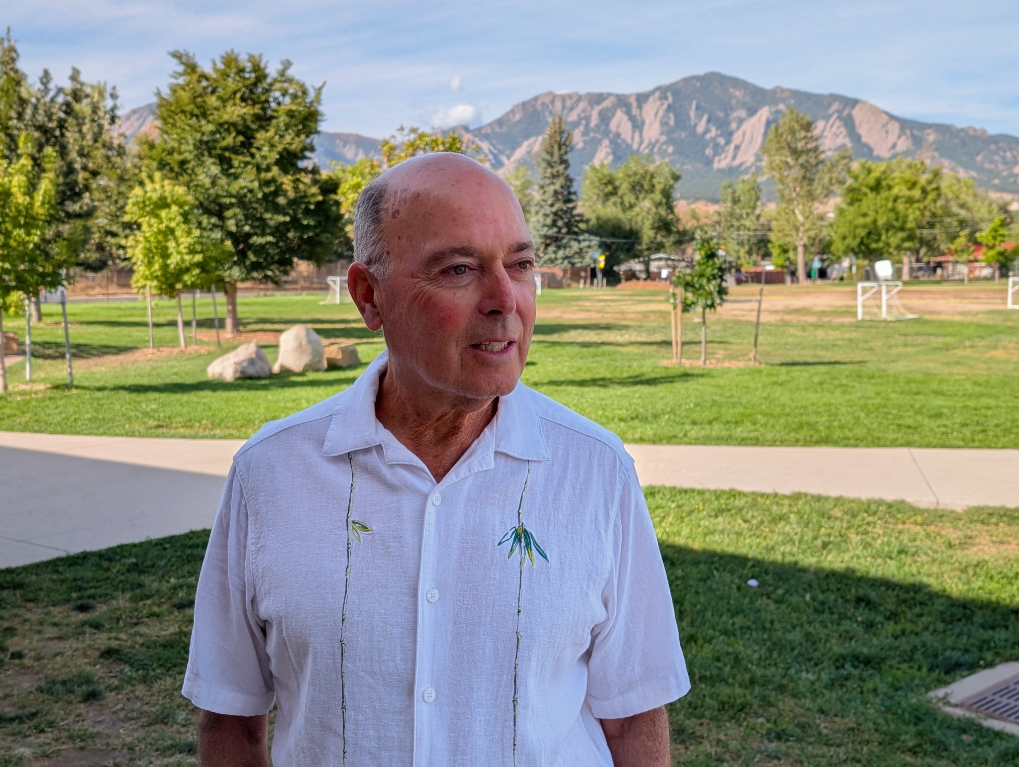 Lee Gilbert outdoors in Boulder with the Flatirons in the background
